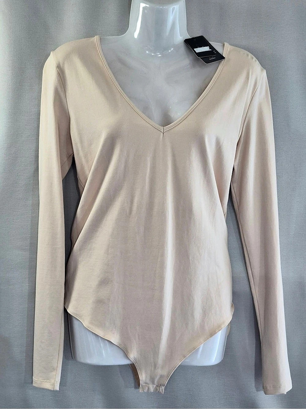 Long Sleeve V-Neck Bodysuit in cream.